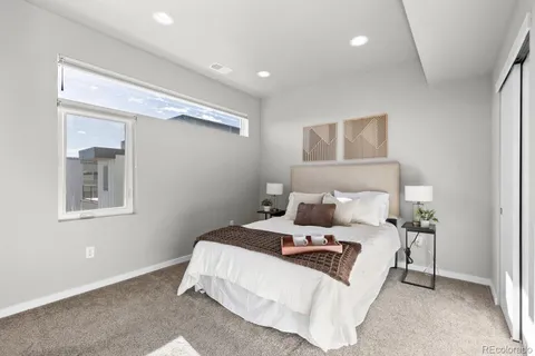 a bedroom with a bed and a night stand