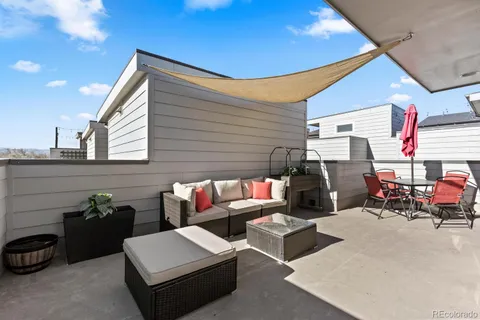 a backyard of a house with fire pit and furniture