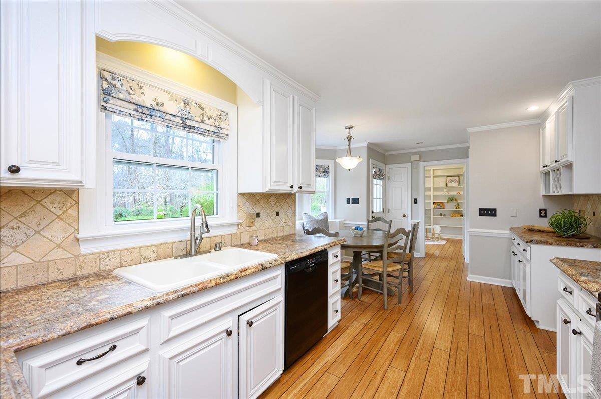 5101 Fielding Drive Raleigh, NC 27606 - Photo 13 of 32 a kitchen with a sink a counter top space and stainless steel appliances