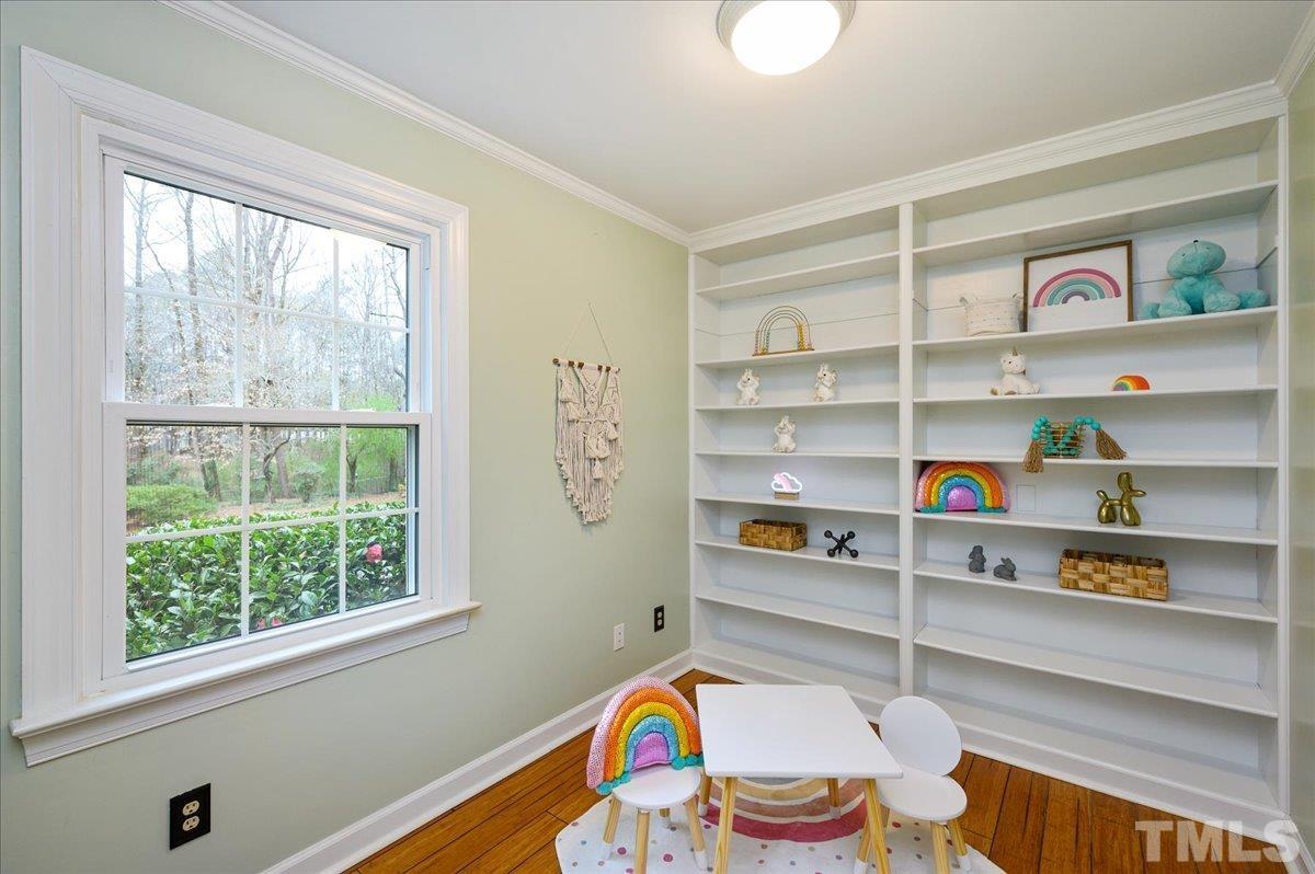 5101 Fielding Drive Raleigh, NC 27606 - Photo 16 of 32 a room with a book shelf and a window