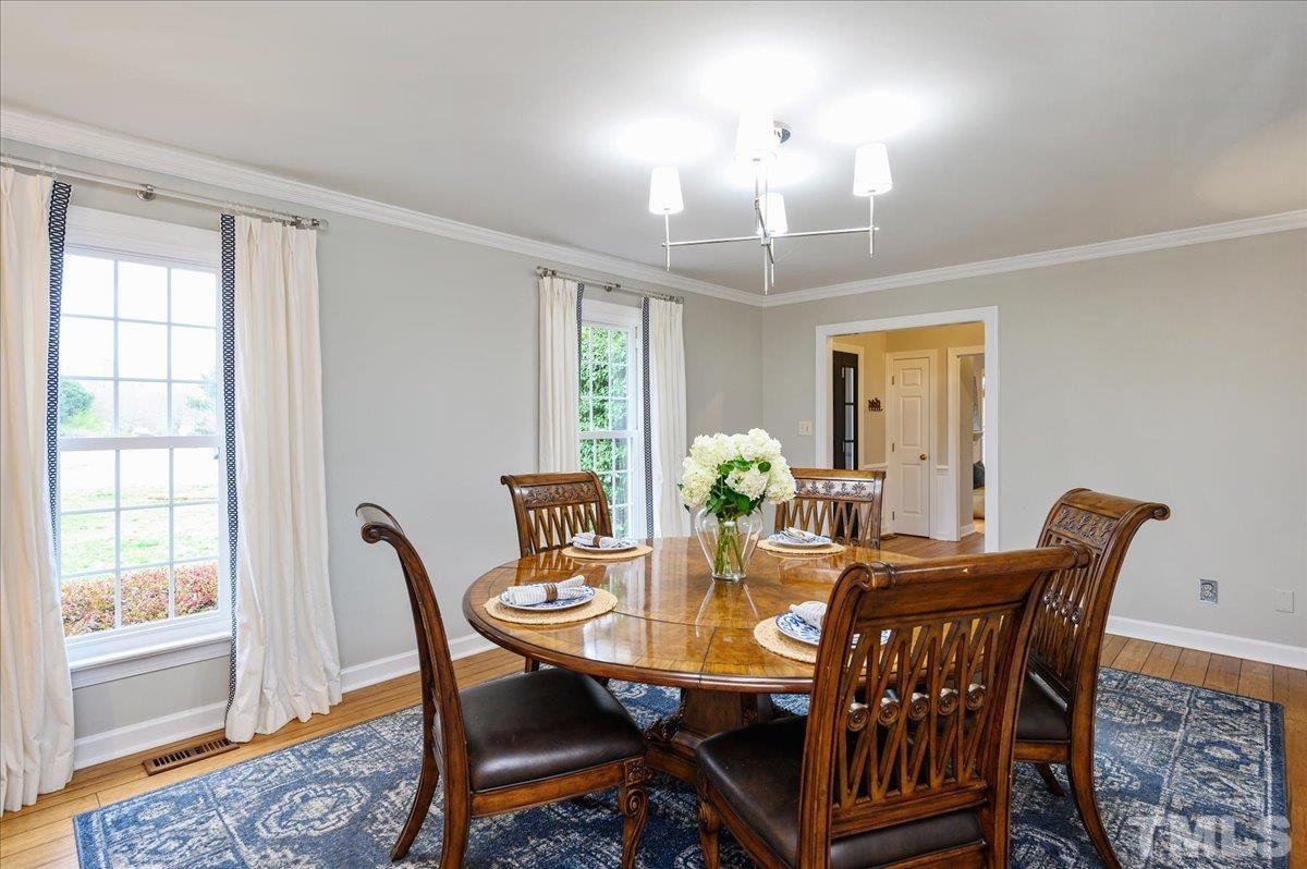 5101 Fielding Drive Raleigh, NC 27606 - Photo 18 of 32 a view of a dining room with furniture and a chandelier