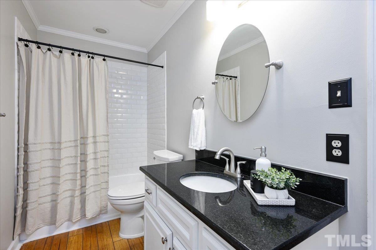 5101 Fielding Drive Raleigh, NC 27606 - Photo 24 of 32 a bathroom with a granite countertop sink and a mirror