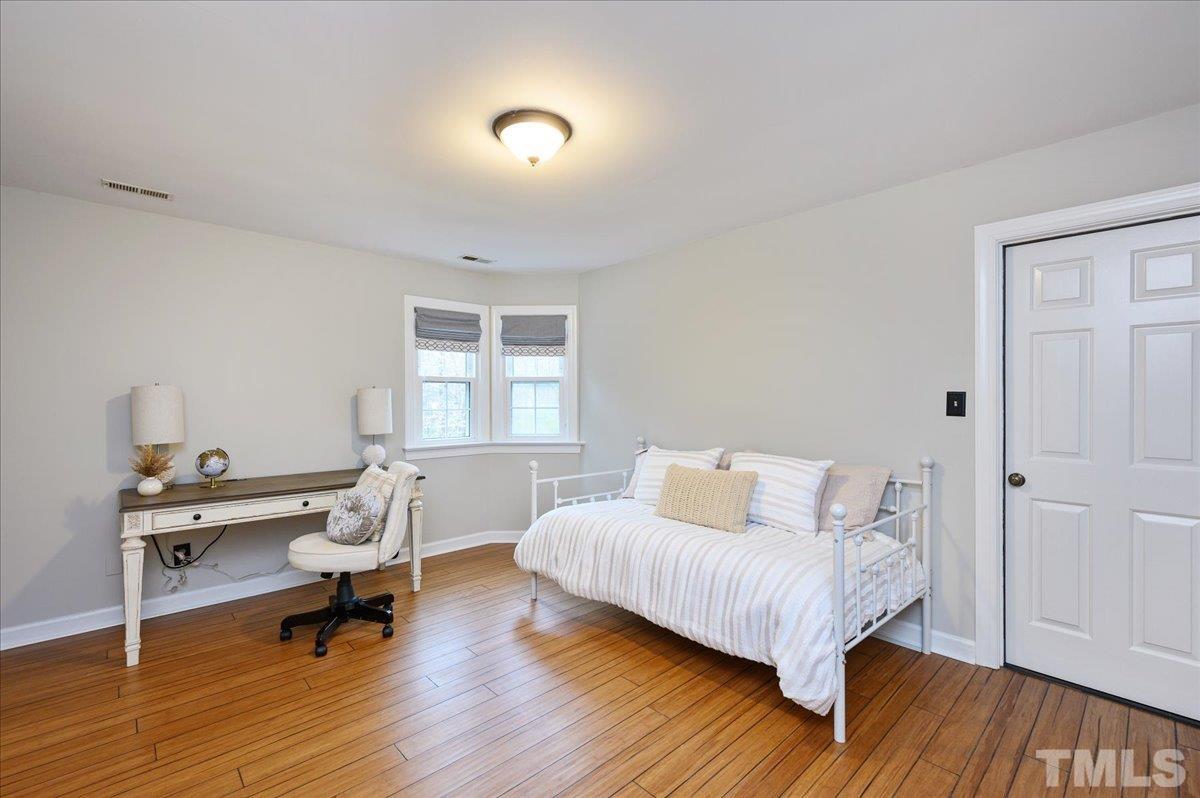 5101 Fielding Drive Raleigh, NC 27606 - Photo 27 of 32 a bedroom with a bed and a window