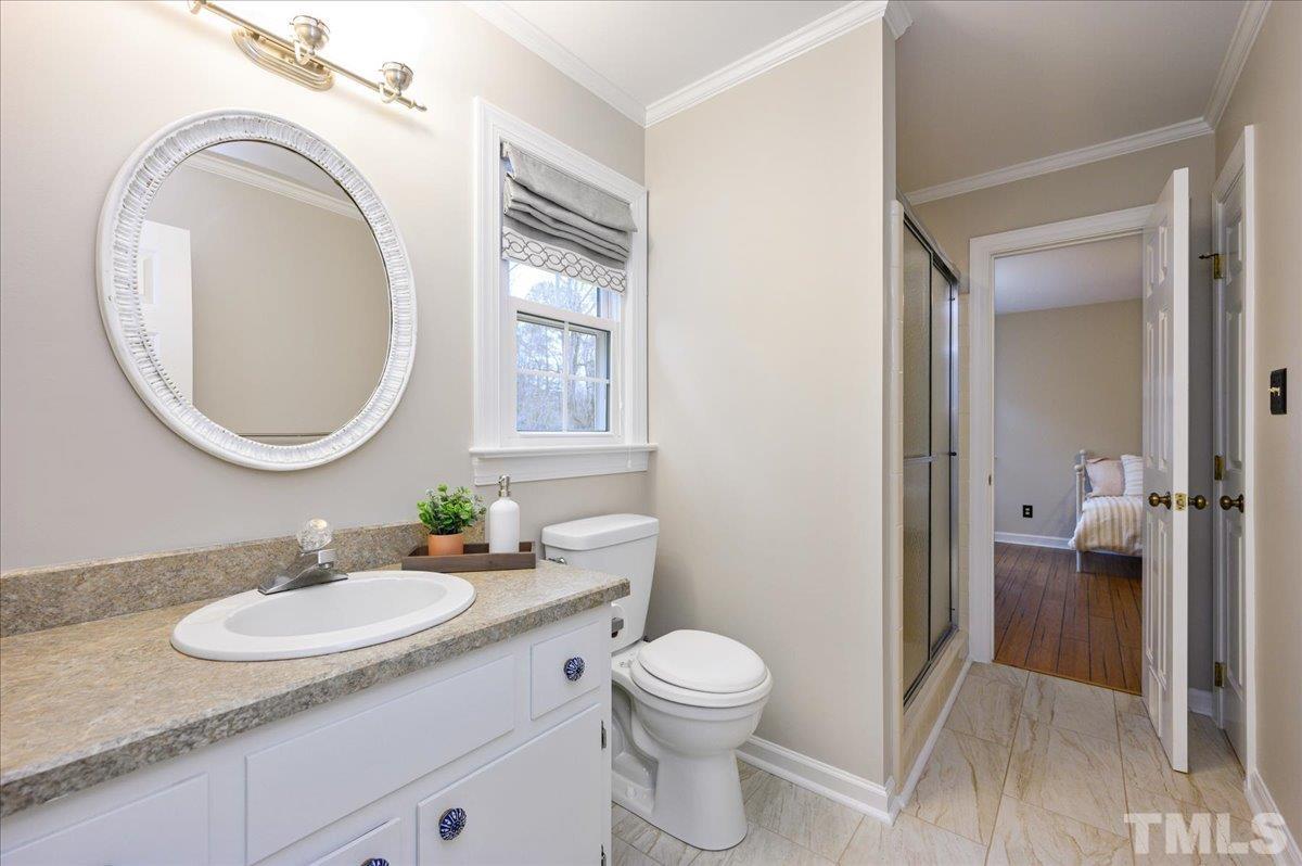 5101 Fielding Drive Raleigh, NC 27606 - Photo 28 of 32 a bathroom with a granite countertop sink a toilet and a mirror