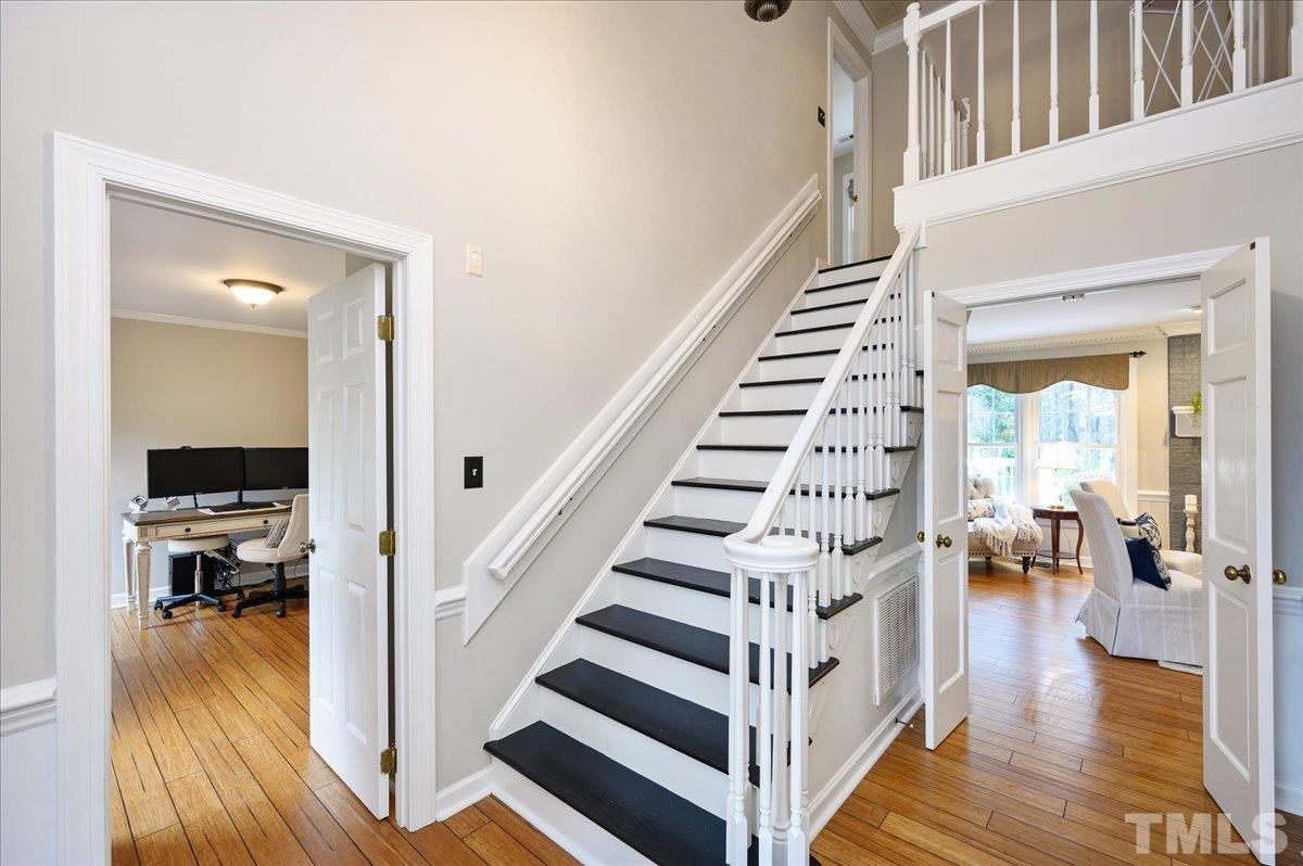 5101 Fielding Drive Raleigh, NC 27606 - Photo 6 of 32 a view of entryway and hall with wooden floor