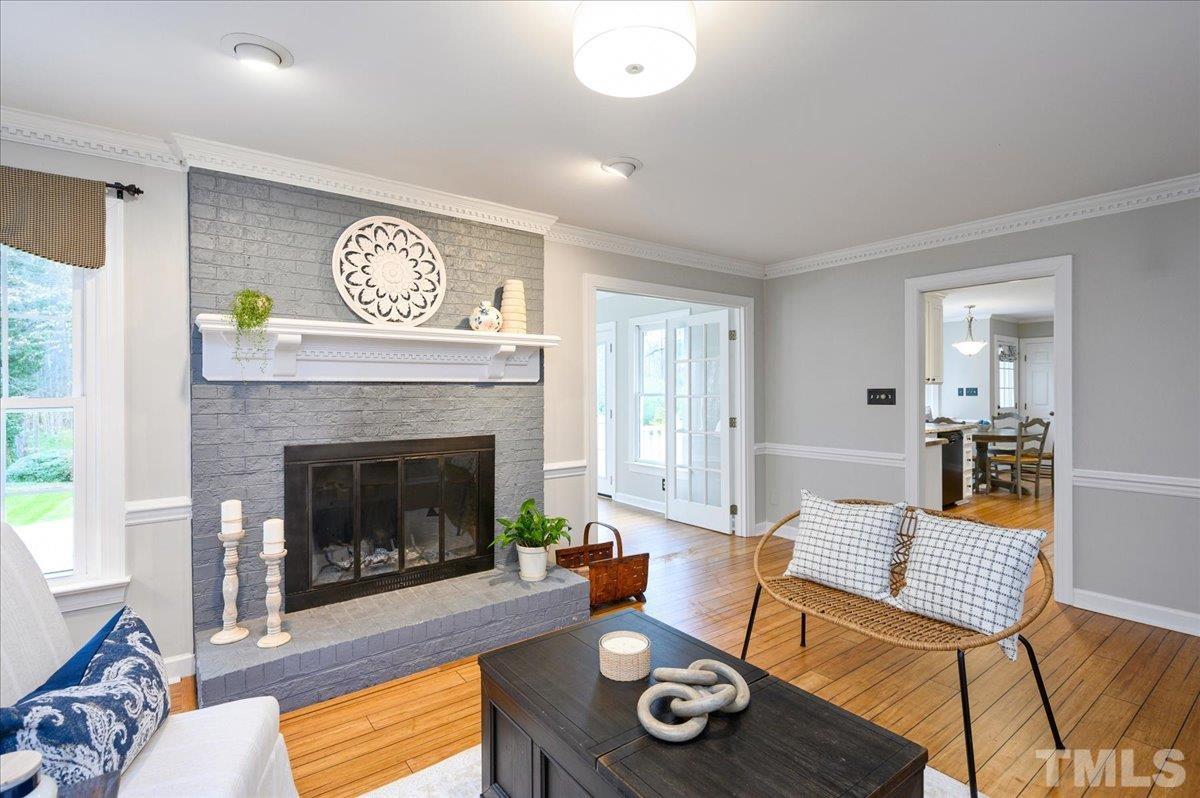 5101 Fielding Drive Raleigh, NC 27606 - Photo 7 of 32 a living room with furniture and a fireplace