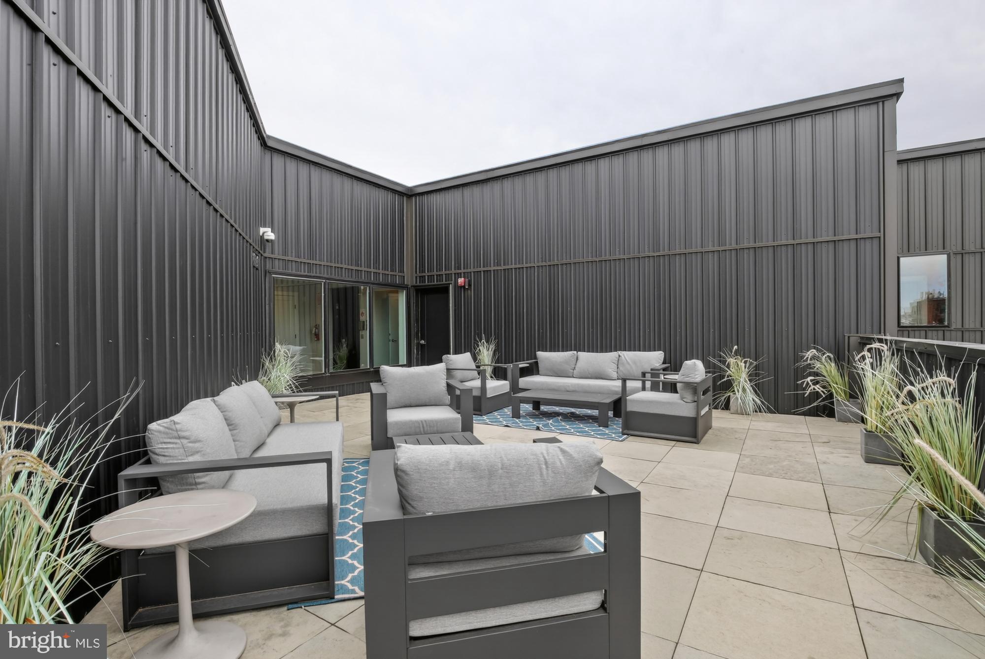 1924 North Front Street, Unit 401 Philadelphia, PA 19122 - Photo 29 of 31 a patio with patio couch and chairs
