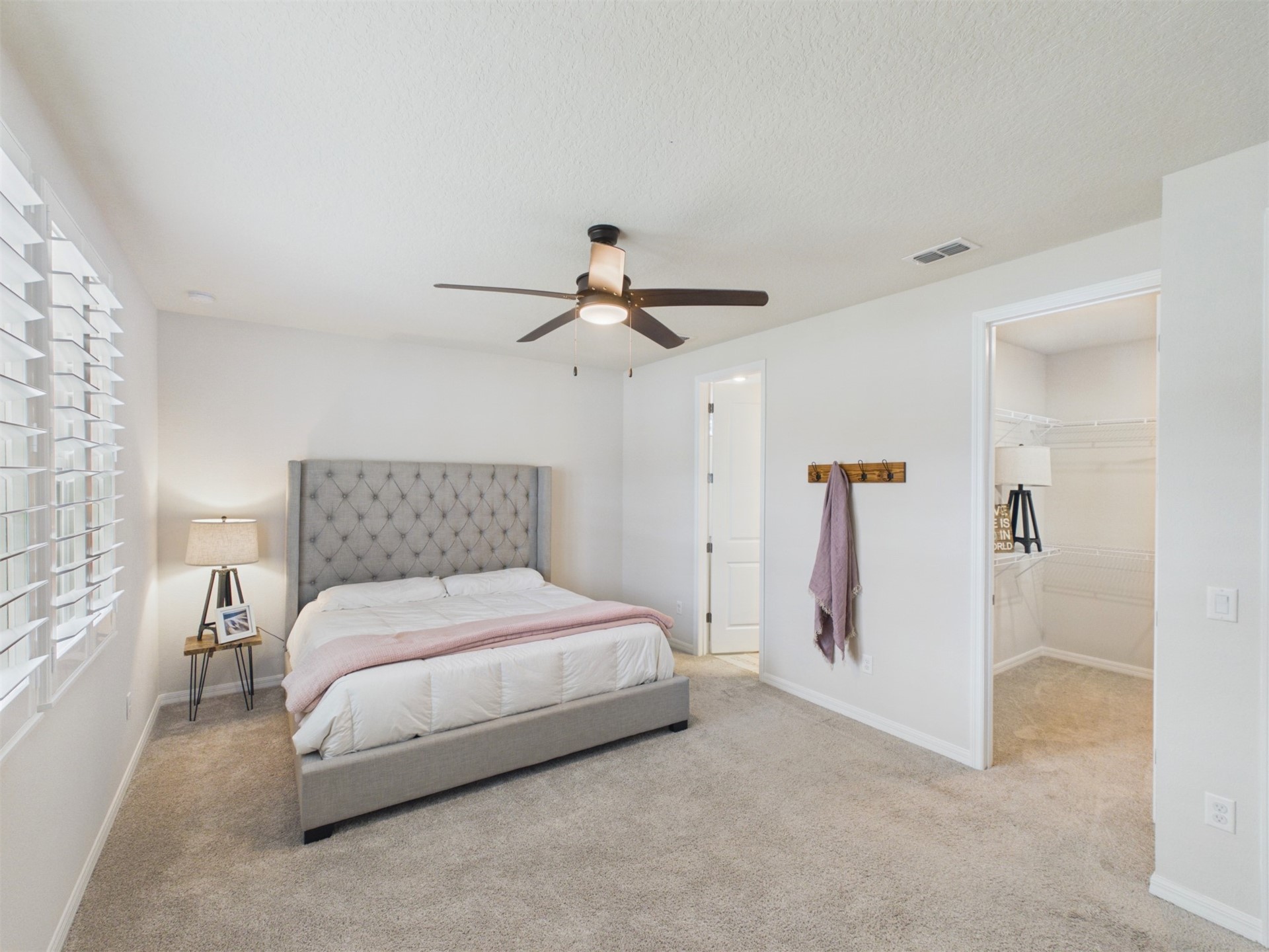 312 Salt Meadow Loop Yulee, FL 32097 - Photo 11 of 22 a bedroom with a bed and a ceiling fan