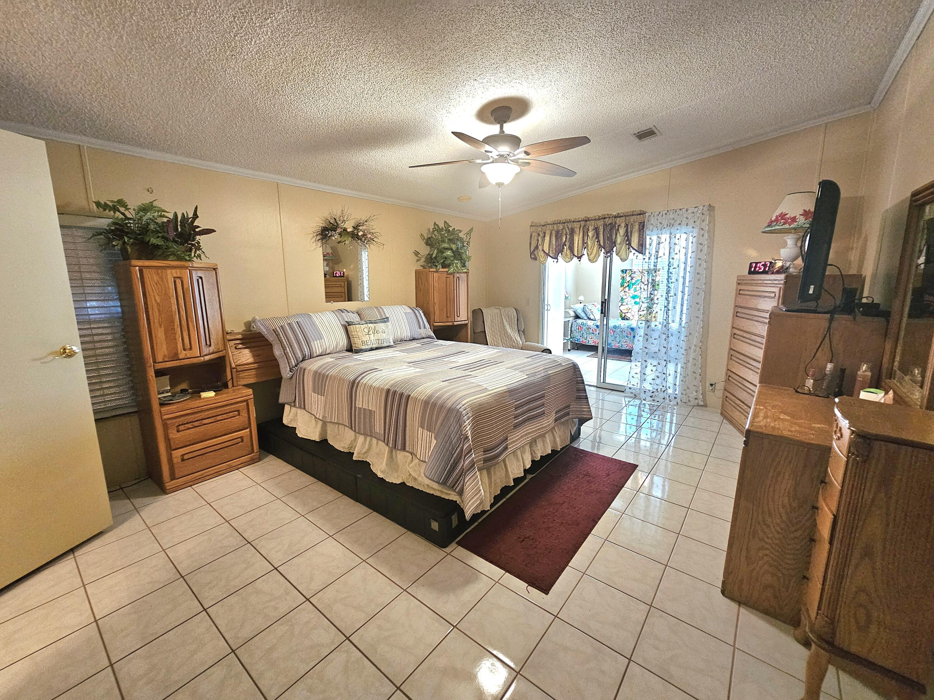 1601 Highway 441, Unit 28 Okeechobee, FL 34974 - Photo 12 of 35 a bedroom with a bed and window