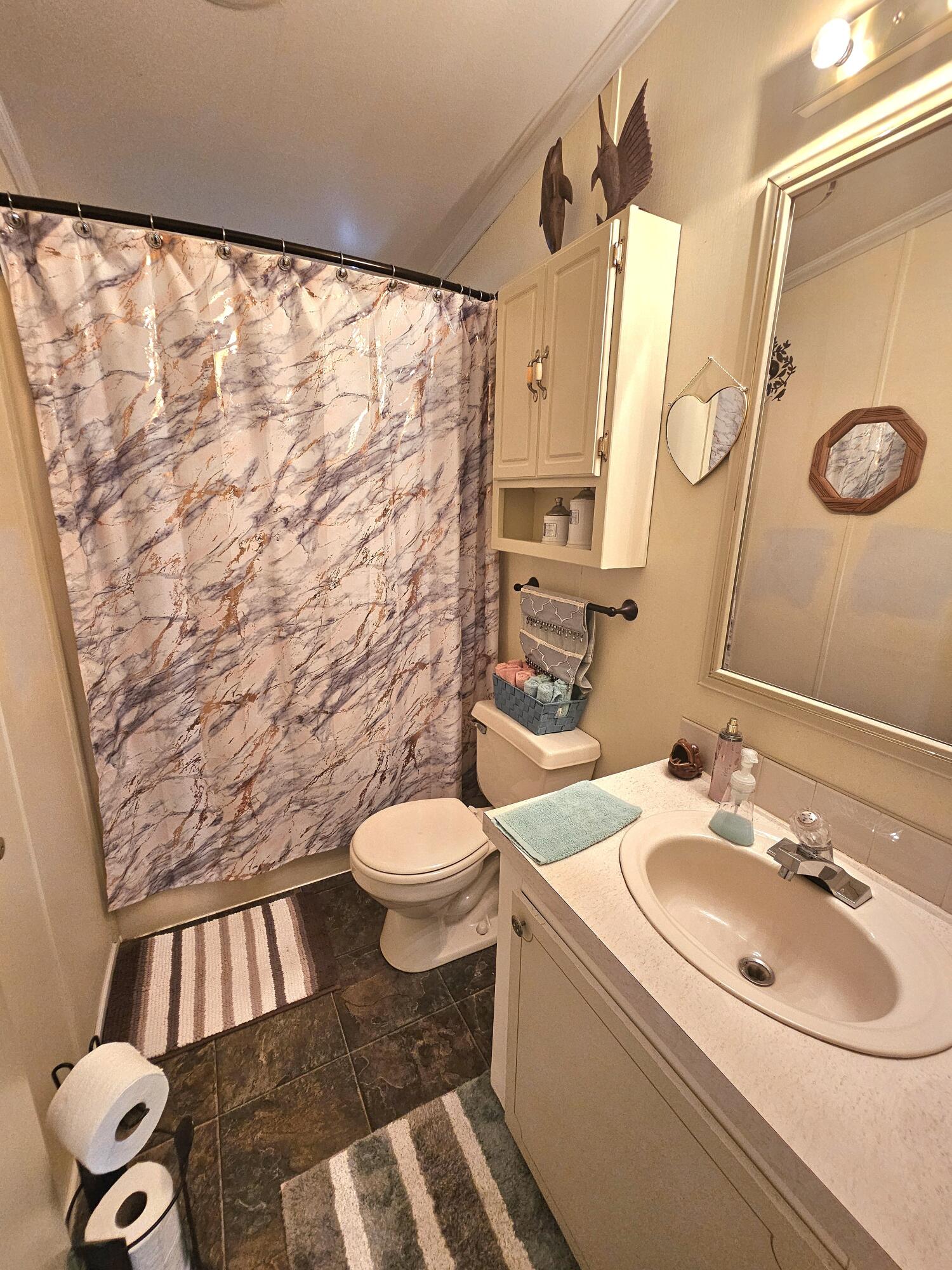 1601 Highway 441, Unit 28 Okeechobee, FL 34974 - Photo 17 of 35 a bathroom with a sink toilet and shower