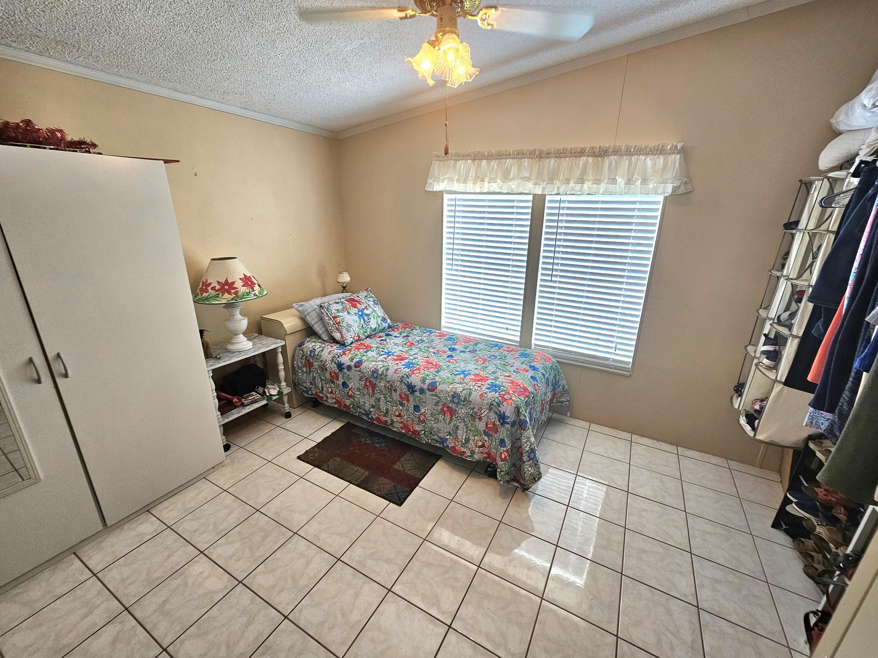 1601 Highway 441, Unit 28 Okeechobee, FL 34974 - Photo 18 of 35 a bedroom with furniture and a window