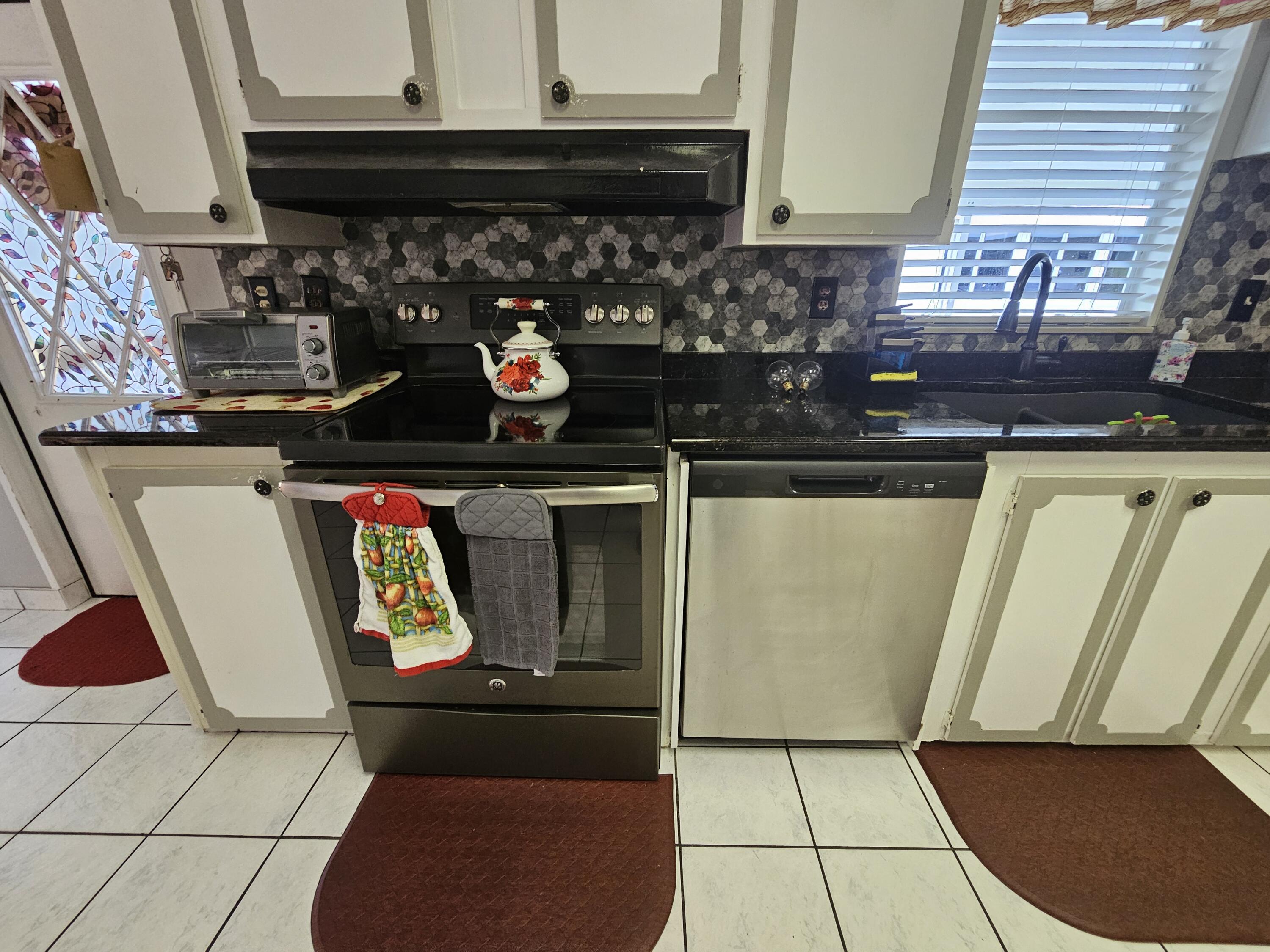 1601 Highway 441, Unit 28 Okeechobee, FL 34974 - Photo 9 of 35 a kitchen with a stove and a refrigerator