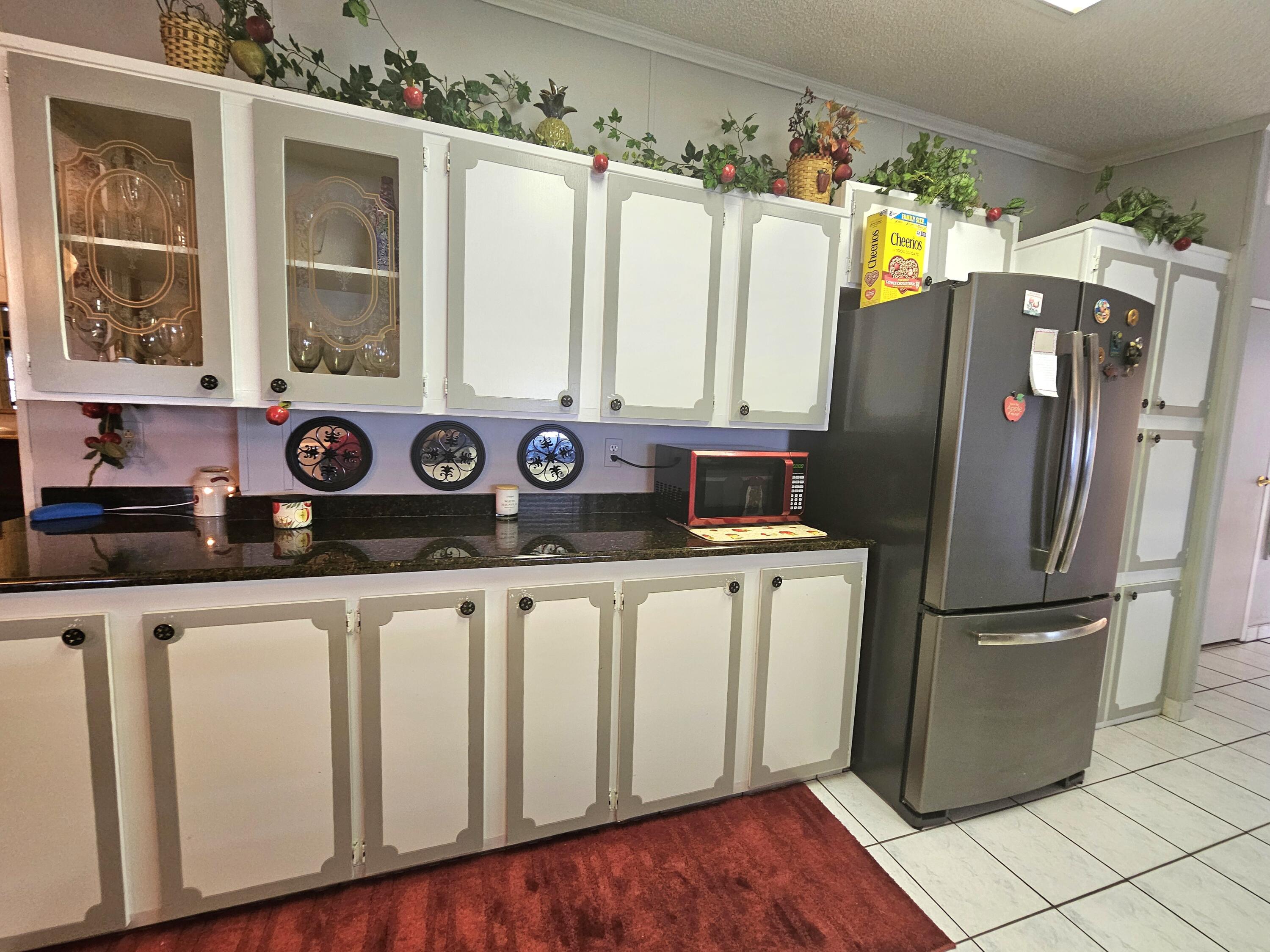 1601 Highway 441, Unit 28 Okeechobee, FL 34974 - Photo 10 of 35 a kitchen with stainless steel appliances granite countertop a refrigerator and a stove