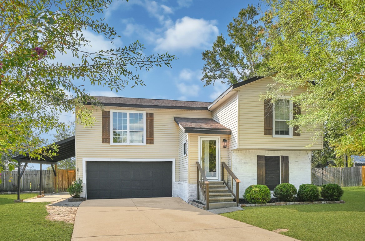 a front view of a house with a garden