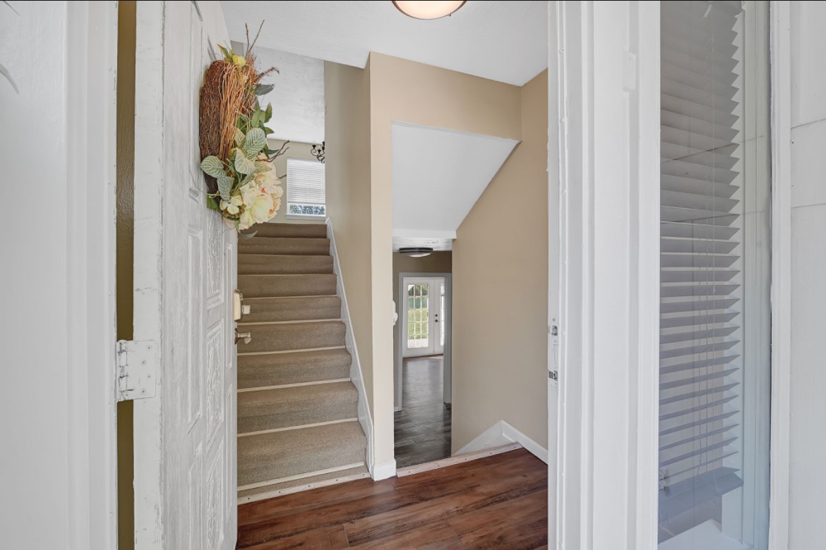 3403 Dryburgh Court Huffman, TX 77336 - Photo 3 of 18 a view of a hallway with wooden floor and stairs