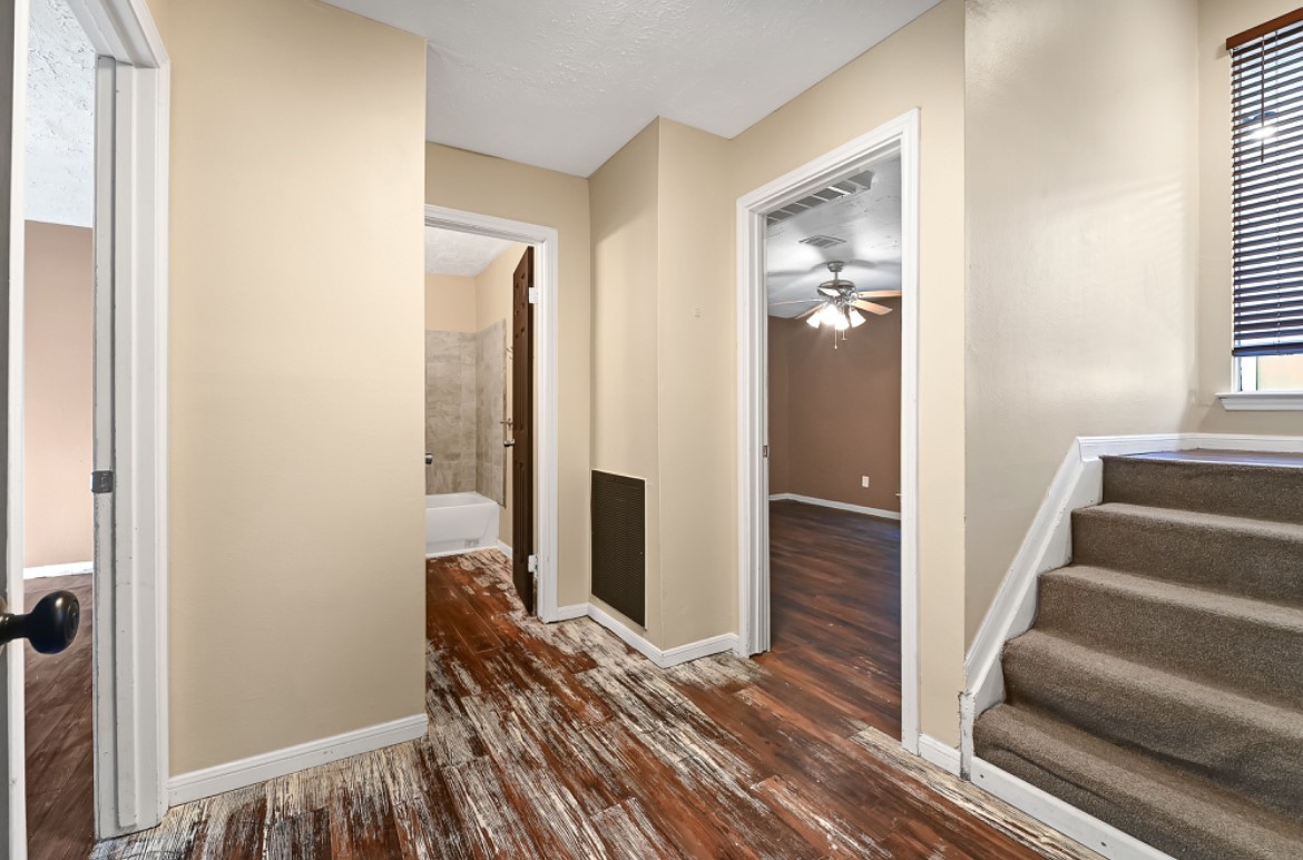 3403 Dryburgh Court Huffman, TX 77336 - Photo 4 of 18 a view of a hallway with wooden floor and staircase