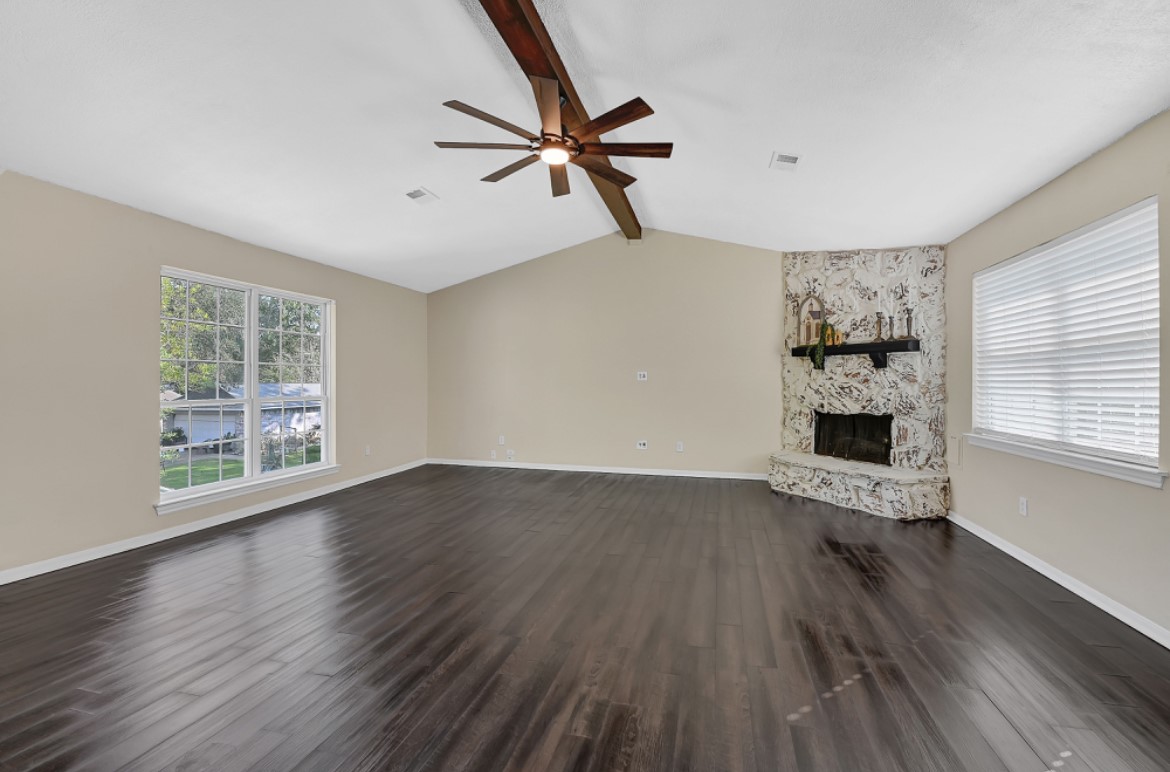 3403 Dryburgh Court Huffman, TX 77336 - Photo 7 of 18 a view of an empty room with a window and wooden floor
