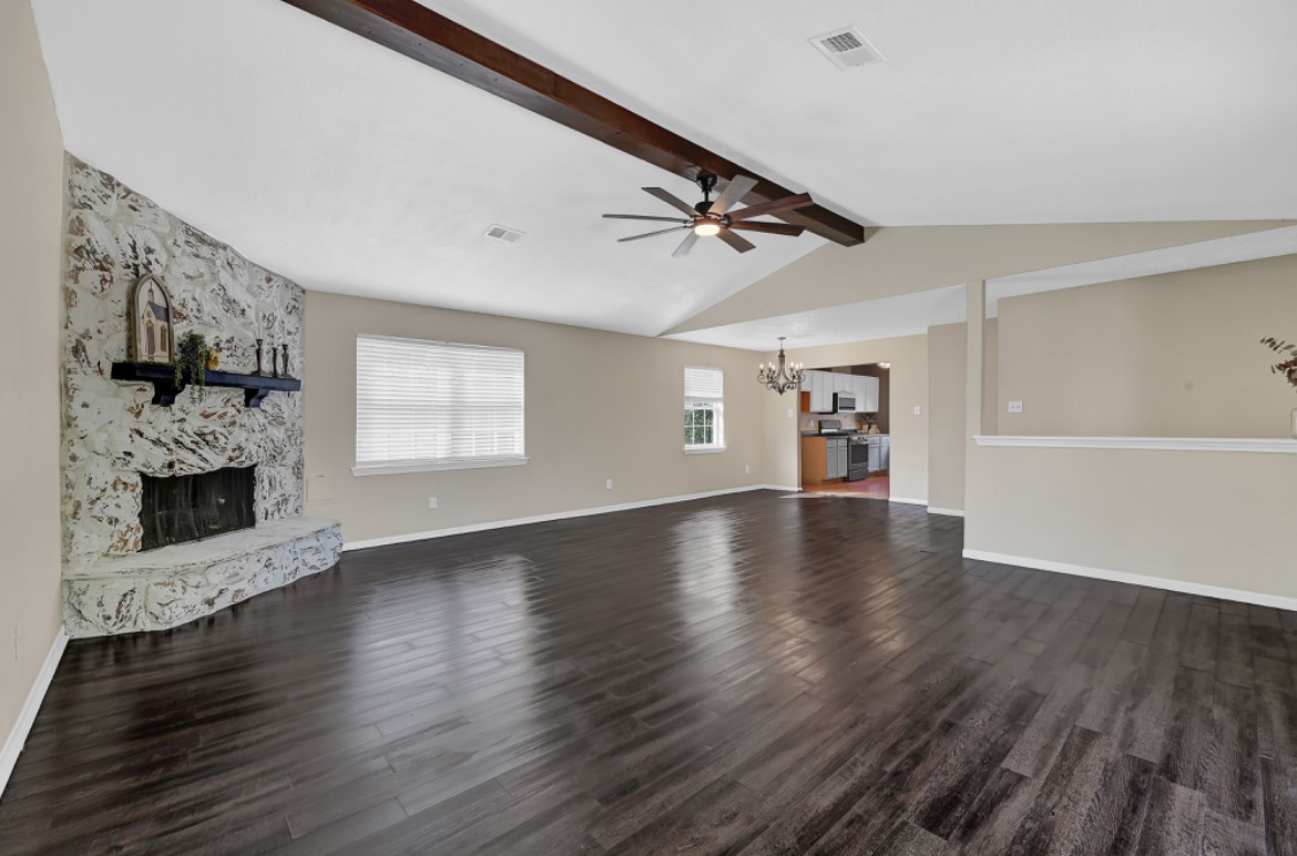 3403 Dryburgh Court Huffman, TX 77336 - Photo 8 of 18 a view of a livingroom with furniture a fireplace and wooden floor