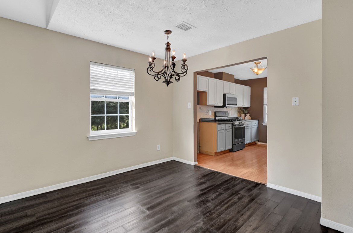 3403 Dryburgh Court Huffman, TX 77336 - Photo 9 of 18 a view of a kitchen with wooden floor and stainless steel appliances