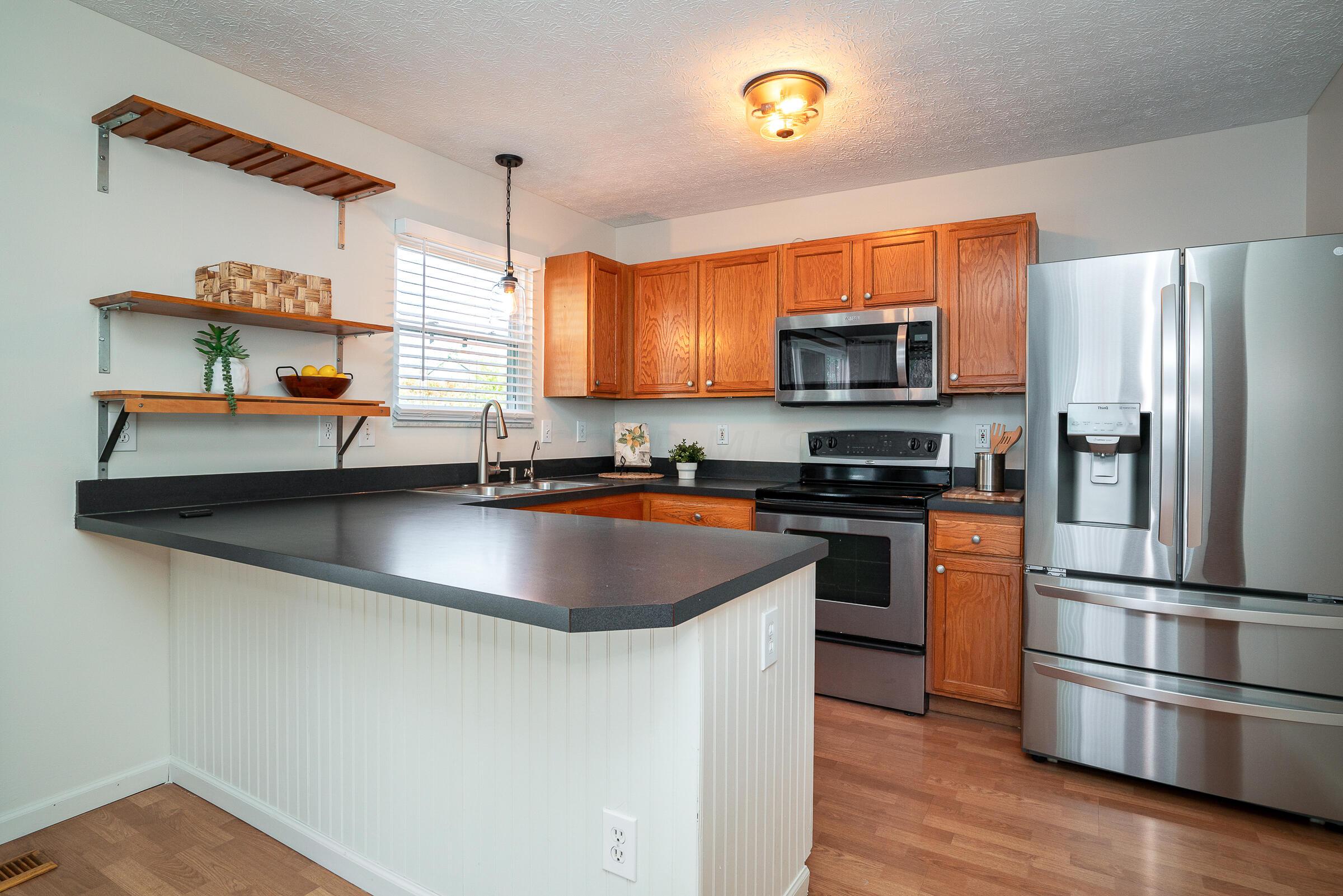 2135 Tonda Lane Grove City, OH 43123 - Photo 8 of 37 A well-equipped kitchen features updated stainless steel appliances