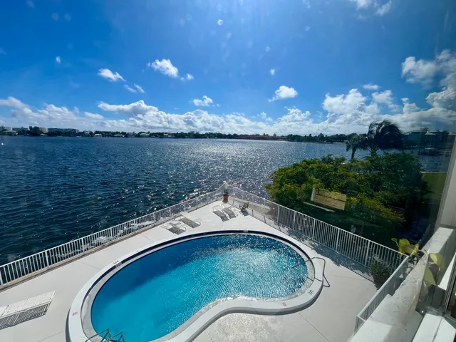 a view of a swimming pool with an outdoor space and a lake view
