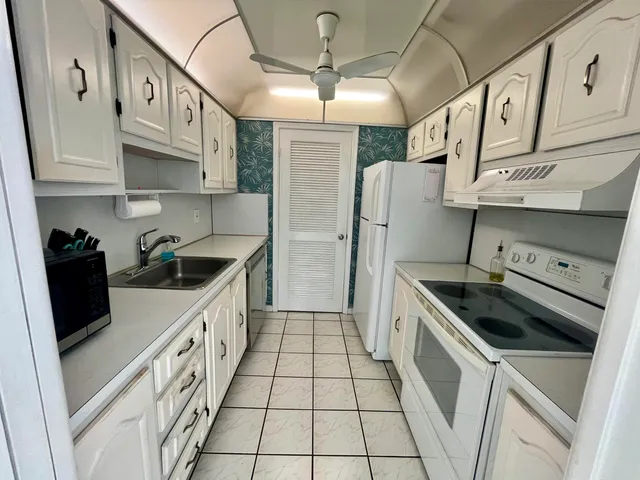 a kitchen with stainless steel appliances granite countertop a sink and cabinets
