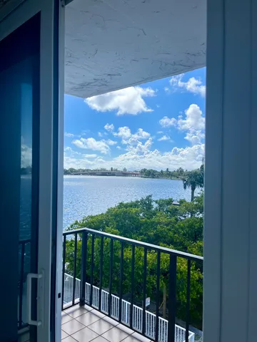 a view of a balcony with a yard