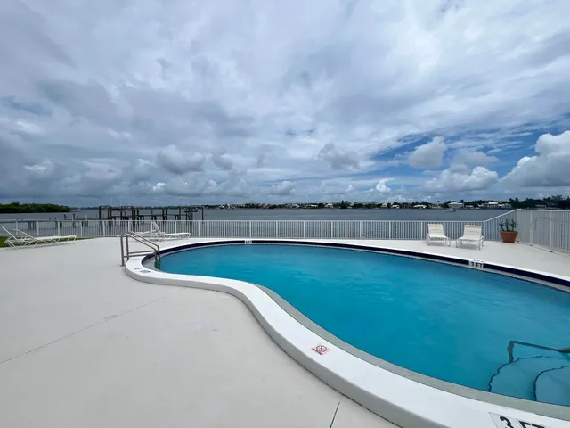 a view of a swimming pool and an outdoor seating