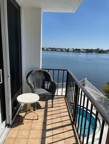 a view of a balcony with chair and wooden floor