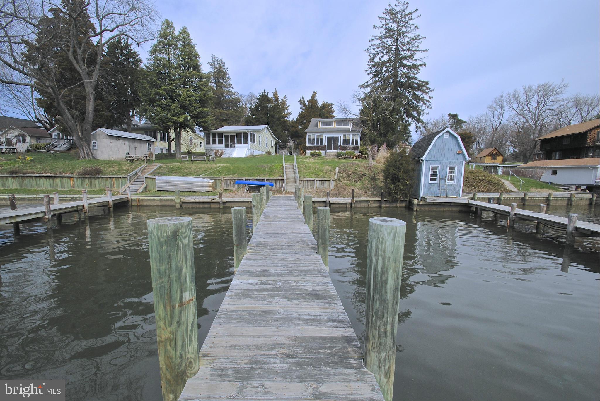 717 Red Cedar Road Annapolis, MD 21409 - Photo 25 of 30 a view of a lake with a yard and large trees