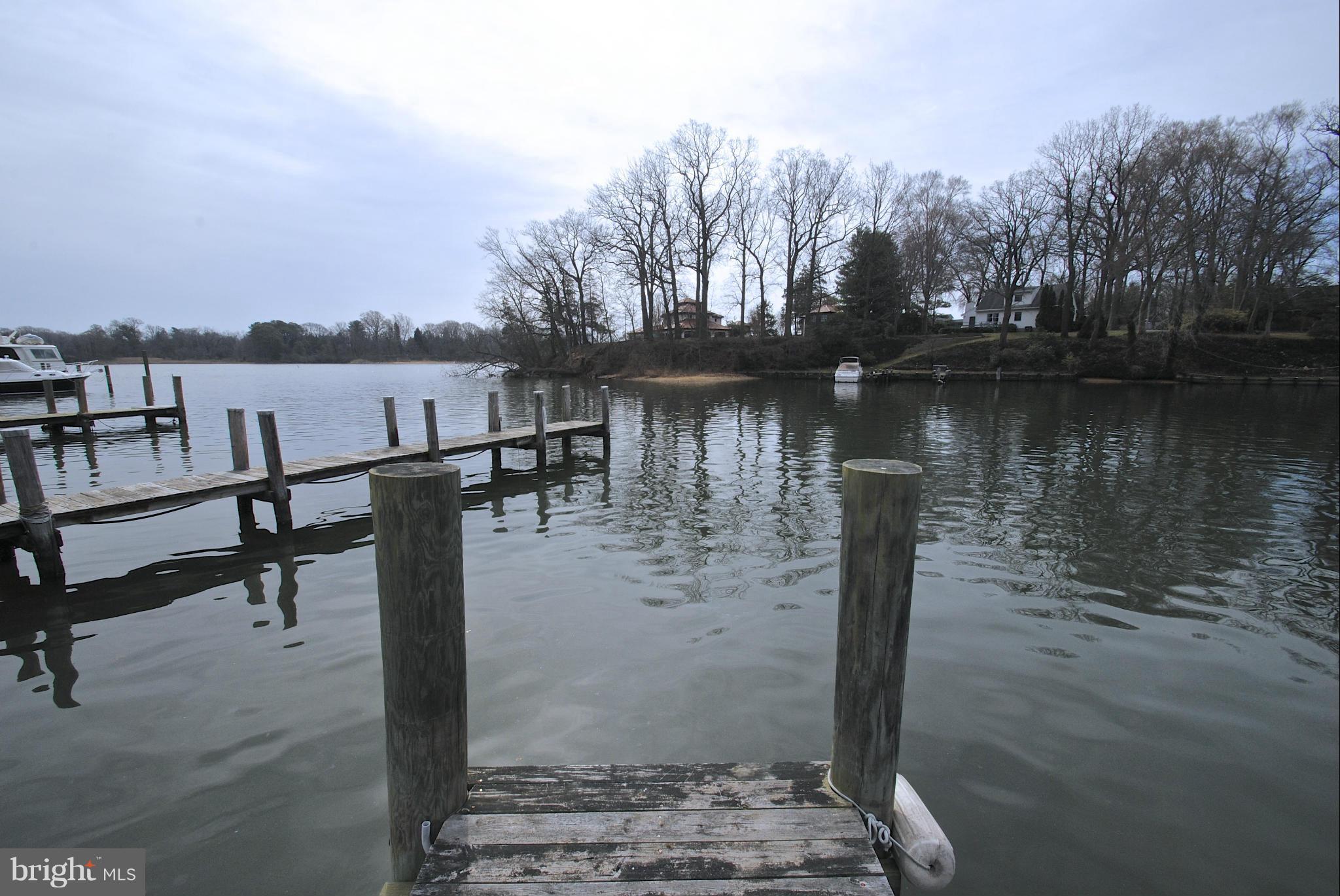 717 Red Cedar Road Annapolis, MD 21409 - Photo 28 of 30 a view of a lake with a bench