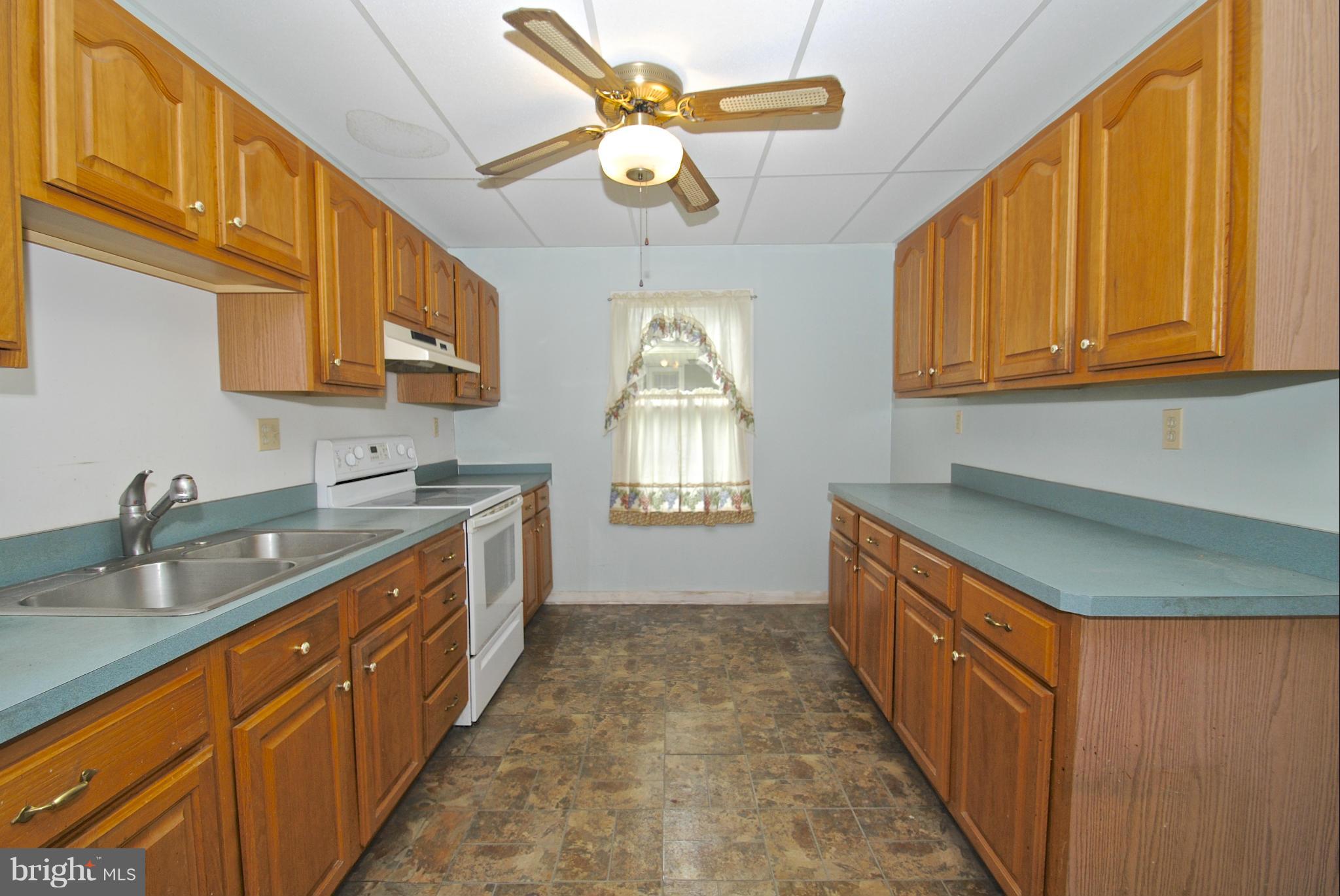 717 Red Cedar Road Annapolis, MD 21409 - Photo 7 of 30 a kitchen with granite countertop a sink stainless steel appliances cabinets and furniture