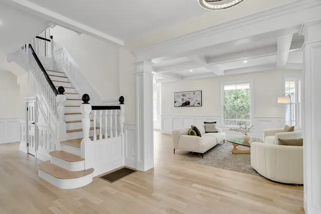 a living room with furniture and stairs
