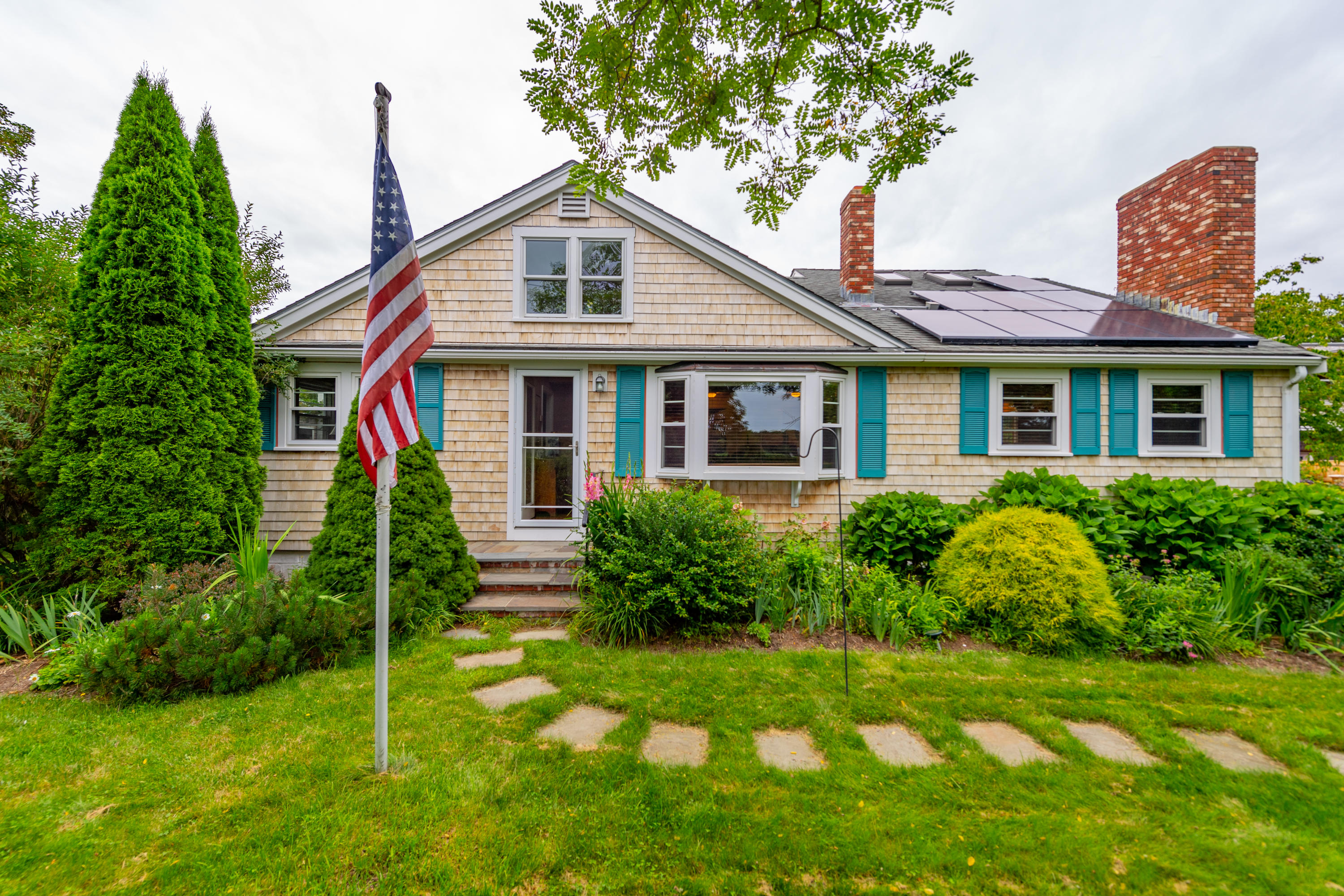 a front view of house with yard and green space