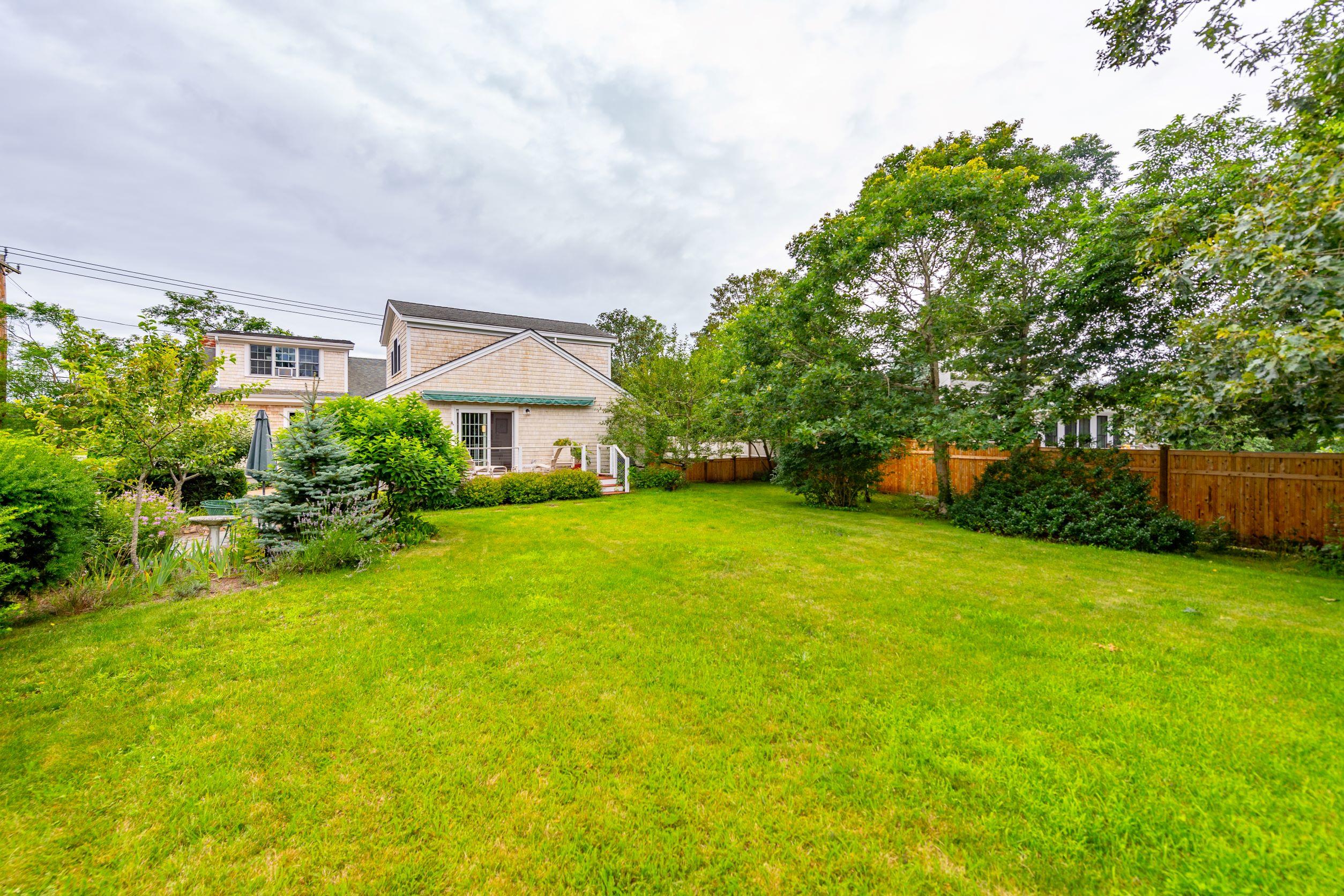 249 West Tisbury Road Edgartown, MA 02539 - Photo 20 of 24 a view of a house with backyard and a garden