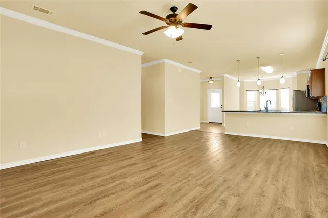 a view of a kitchen with a sink and a refrigerator