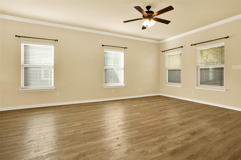 4813 Pinnacle Place Denison, TX 75021 - Photo 18 of 28 a view of an empty room with window and wooden floor