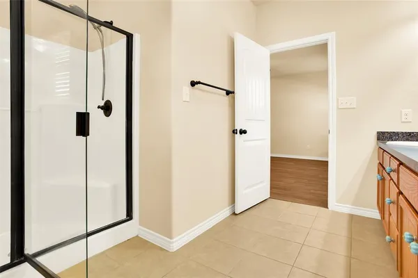 a bathroom with a shower and a glass door