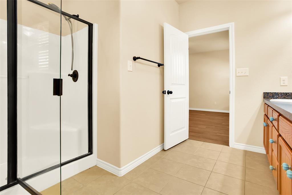 4813 Pinnacle Place Denison, TX 75021 - Photo 22 of 28 a bathroom with a shower and a glass door