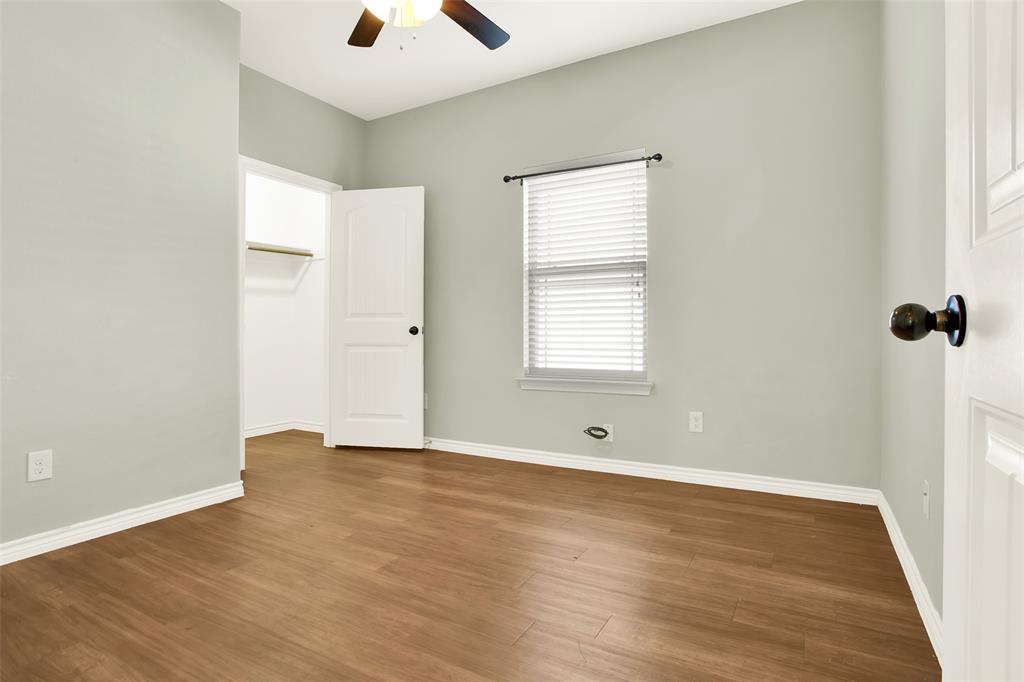 4813 Pinnacle Place Denison, TX 75021 - Photo 24 of 28 an empty room with wooden floor and windows