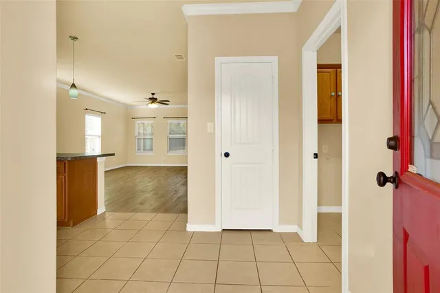a view of a hallway with wooden floor and a bathroom