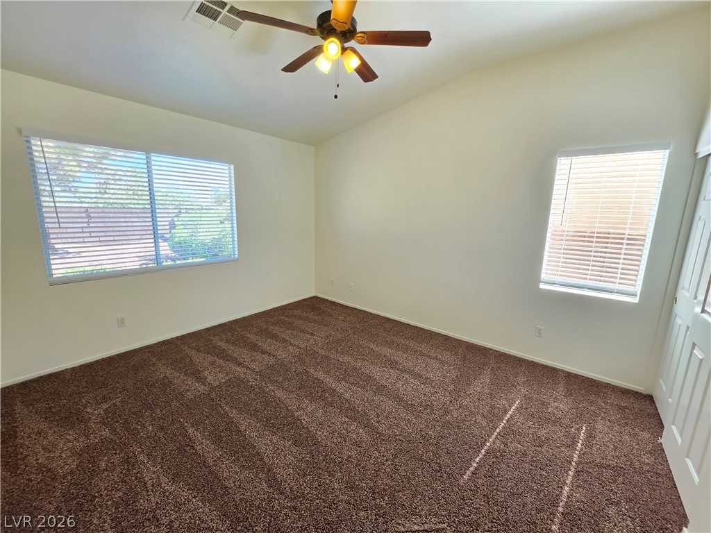 1154 Point Success Avenue Henderson, NV 89014 - Photo 20 of 26 A spacious chamber with soft carpeting offers a comfortable living space.