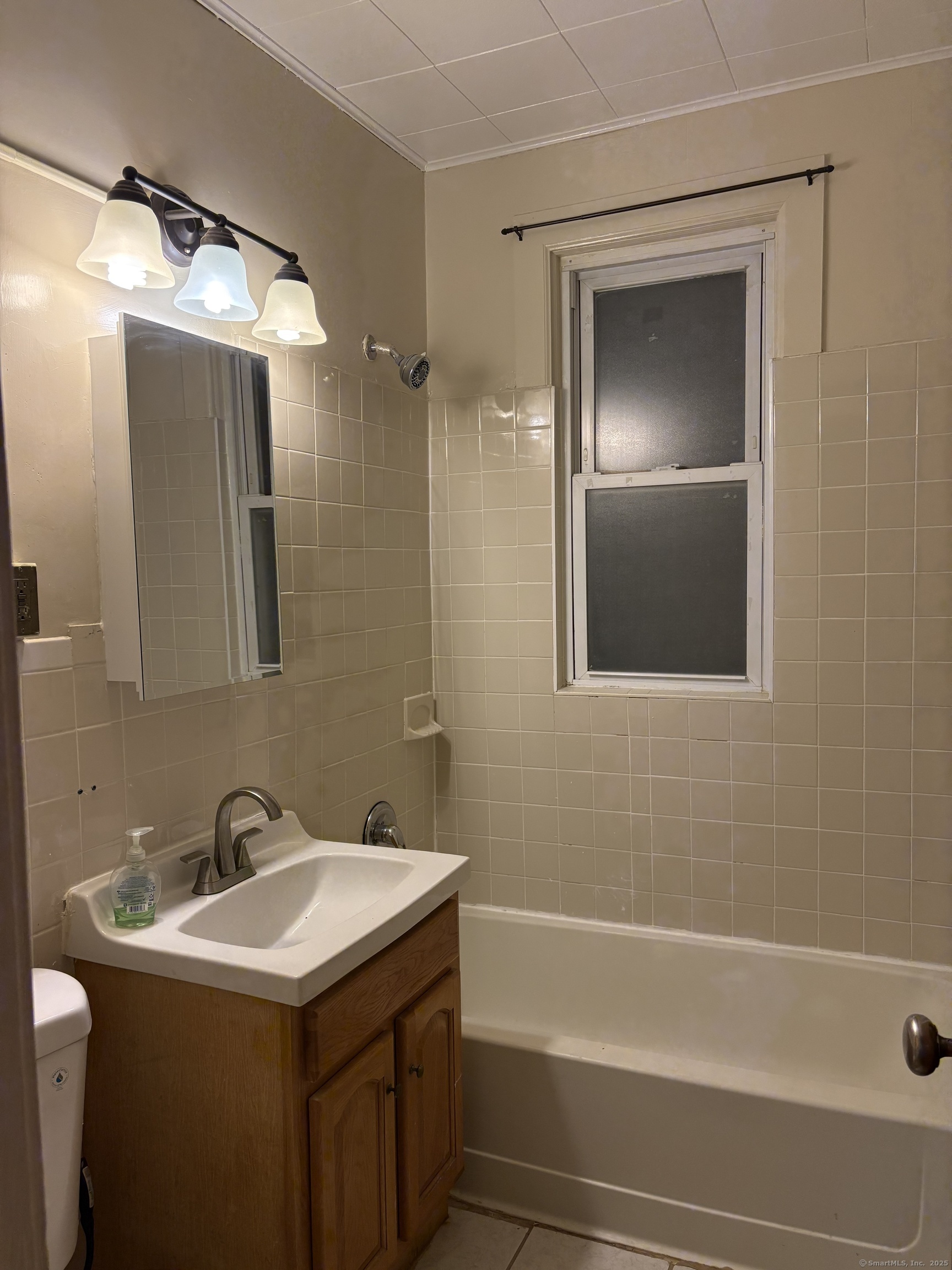 Undisclosed Address Hartford, CT 06112 - Photo 3 of 7 a bathroom with a sink and a mirror