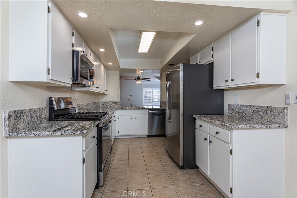 230 Bethany Road, Unit 306 Burbank, CA 91504 - Photo 11 of 44 a kitchen with a sink stove and refrigerator