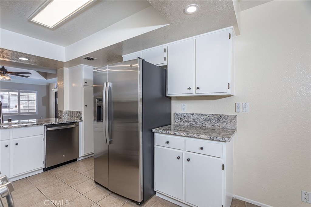 230 Bethany Road, Unit 306 Burbank, CA 91504 - Photo 12 of 44 a kitchen with stainless steel appliances granite countertop a refrigerator and a sink