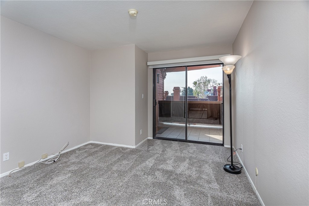 230 Bethany Road, Unit 306 Burbank, CA 91504 - Photo 23 of 44 an empty room with sliding glass door