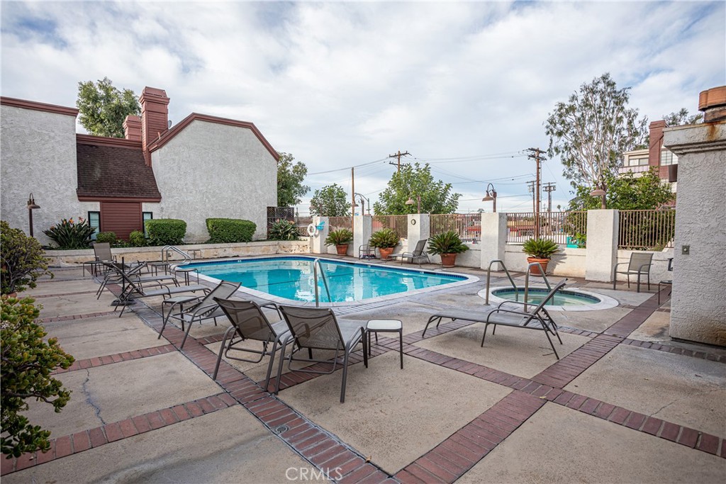 230 Bethany Road, Unit 306 Burbank, CA 91504 - Photo 39 of 44 a swimming pool with outdoor seating and yard