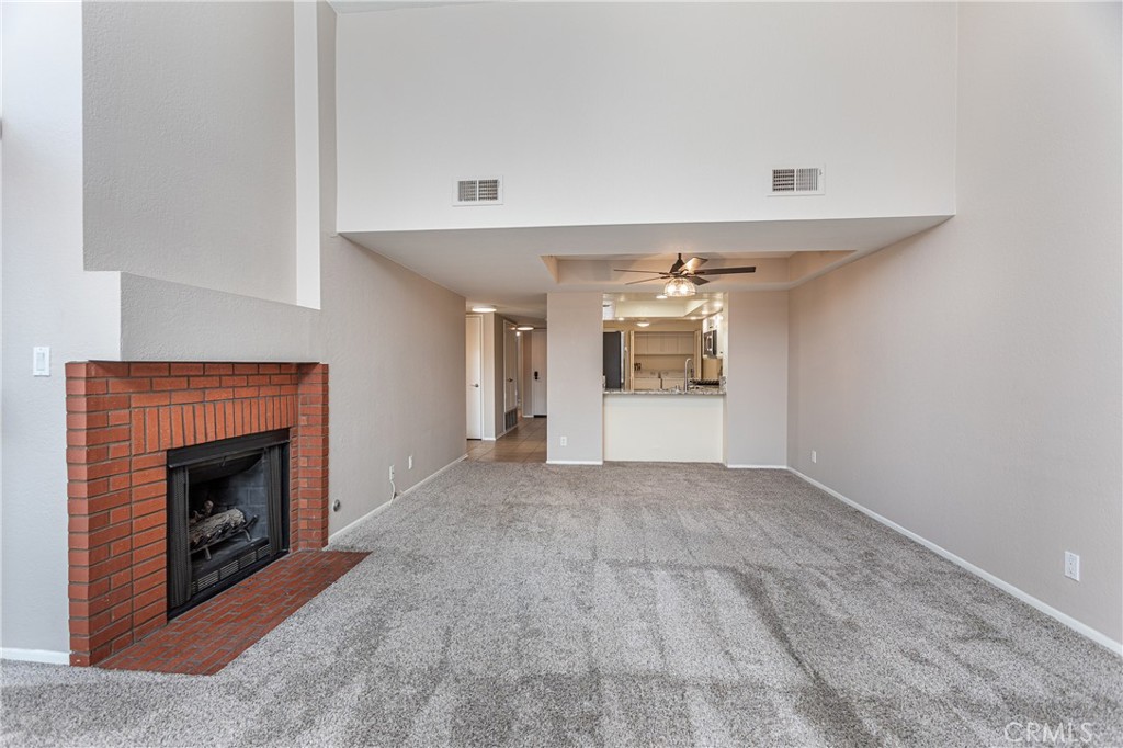 230 Bethany Road, Unit 306 Burbank, CA 91504 - Photo 4 of 44 an empty room with a fireplace and window