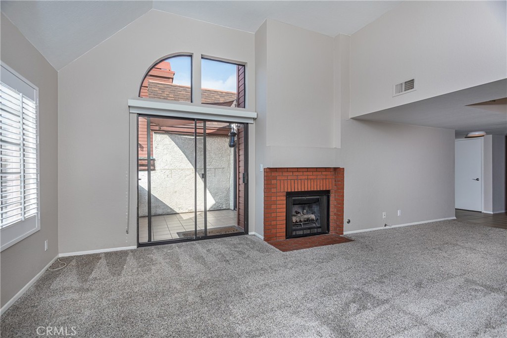 230 Bethany Road, Unit 306 Burbank, CA 91504 - Photo 5 of 44 an empty room with fireplace cabinet and windows