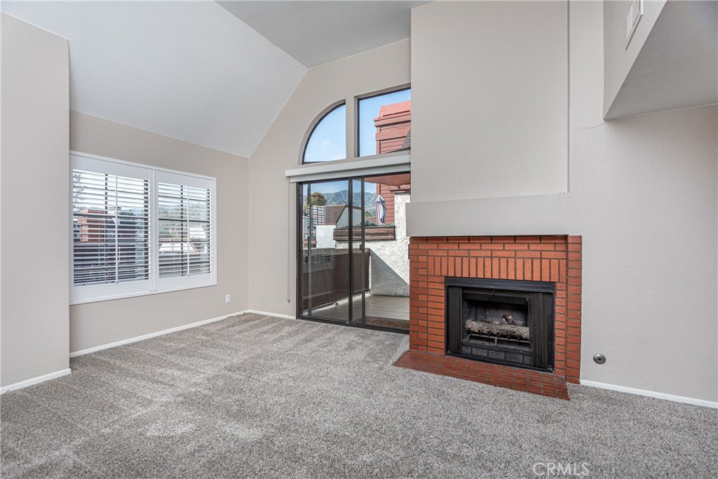 230 Bethany Road, Unit 306 Burbank, CA 91504 - Photo 6 of 44 a view of an empty room with a fireplace and a window
